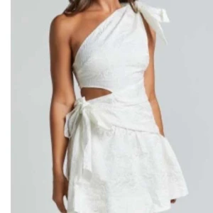 Vit axelbandslös klänning från Show po - Snygg vit klänning med oneshoulder-design och knytning i midjan. Perfekt för student. Strl 42.🥰
