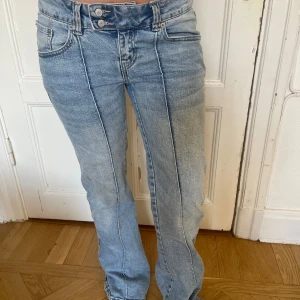 Ljusblå bootcut jeans - Säljer ett par ljusblå jeans med bootcut passform och snygga pressveck längs benen.