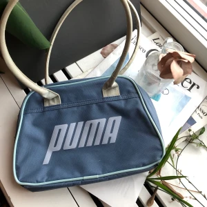 Väska puma - Gullig liten vintage väska från puma. Köpt second hand men bra skick ❤️Har ett innerfack och rymmer relativt mycket. Köpt här och kommer tyvärr inte till användning som jag hoppats