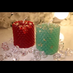 Jelly Gem Candles - Glossy, squishy, and full of charm-these jelly-textured candles sparkle with gold flakes and rich color. Available in ruby red and emerald green, they feel as good as they look. Style: Jiggly texture with gold accents Size - H: 7.6 cm, B:6.6cm