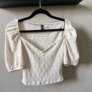 Vit somrig topp från H&M - Vit somrig topp från H&M divided. Är använd ett fåtal gånger och har inga slitningar. 