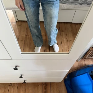 Ljusblå wide jeans  - Säljer ett par ljusblå jeans med bred passform och raka ben. Jeansen har klassisk femficksdesign, hög midja och är tillverkade i denim med snygg tvättad effekt. Perfekta för en avslappnad och trendig look.