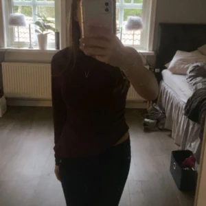 Vinröd oneshoulder topp Gina Tricot - Säljer en vinröd oneshoulder topp från Gina Tricot i storlek S. Toppen har endast lång ärm på ena sidan , vilket ger en snygg asymmetrisk look. Materialet är stretchigt och sitter tight. Perfekt för dig som vill sticka ut lite extra.