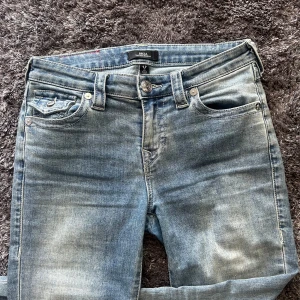Ljusblå jeans från True Religion - Säljer ett par jättefina ljusblå jeans från True Religion med den klassiska knapp fickan. Midjemått: 35cm Innerbenslängd: 83cm. Tveka aldrig att kontakta för frågor💕💕💕