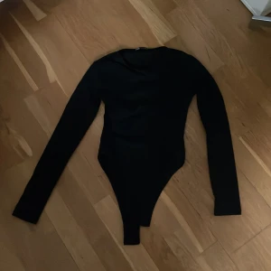 Långärmad svart body från Zara  - En snygg vart långärmad body från Zara. Den har en normal hals utan urringningar och har en tajt passform. I st S men skulle säga att den även passar M och XS då den har ett stretchigt material. Skriv om du har frågor❤️