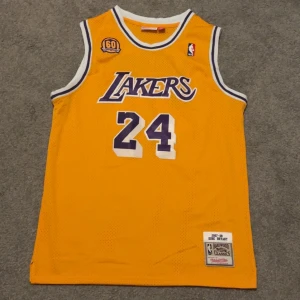 Mitchell ness Kobe Bryant lakers jersey  - Säljer en ikonisk Lakers Kobe Bryant Jersey i storlek xl men är mer som storlek L perfekt för dig som är intresserad i basket. 