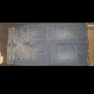 Blå raka jeans från Zara med råa kanter - Säljer ett par blå jeans från Zara med raka ben och råa, fransiga benslut. Jeansen har klassisk femficksdesign och en ljus tvätt med lätt slitning på ena benet. Perfekta för en avslappnad och trendig look.