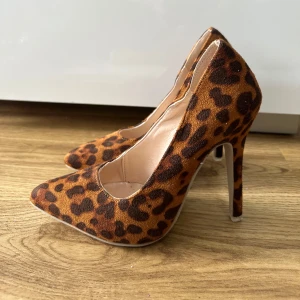 Leopardmönstrade pumps med hög klack - Säljer ett par snygga pumps med leopardmönster och hög smal klack. Skorna har spetsig tå och är klädda i ett mockaliknande material. Perfekta för dig som vill sticka ut med din stil. Oanvända storlek 35 mer som 36