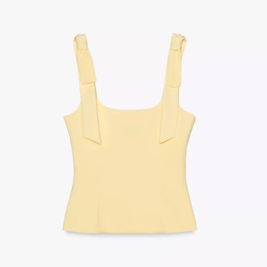 Gul linnetopp med rosetter på axelbanden - 1