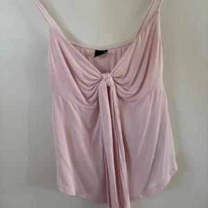 Ljusrosa linnetopp med knyt - Linne från Gina tricot, jätte fin till sommaren. Lite noppig men annars i bra skick! 