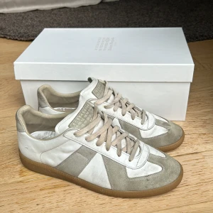 Maison Margiela gats - Säljer min Maison Margiela gats. Köpta för ett år sen. Den enda defekten är den man kan se på tredje bilden där tråden har lossnat lite, men inget hål finns då det vita lädret går även under mockan. KVITTO FINNS!