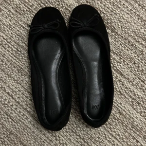 Svarta ballerinaskor H&M - Snygga svarta ballerinaskor från H&M i storlek 37. Säljer skorna pga de är lite för stora för mig. Skorna är även i bra skick då dom bara är använda en gång. Skriv gärna om det finns några frågor💘La ut dessa skor för ett tag sen men det blev tyvärr lite strul med annonsen! Öppen för prisförslag.