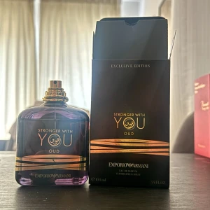 Emporio Armani Stronger With You Oud sample 3ml - Lyxig parfym från Emporio Armani, Stronger With You Oud, i en elegant mörklila glasflaska med guldiga detaljer och svart/guldig kartong. Flaskan rymmer 100 ml och har exklusiv design med stilren form och guldfärgad spraykork.