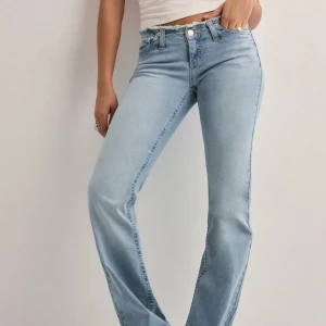 Ljusblå bootcut jeans  - Säljer ett par ljusblå jeans med bootcut-modell och rå, fransad midjekant. Jeansen har klassisk femficksdesign, gylf med dragkedja och knapp samt en snygg, något utsvängd passform. Perfekta för en avslappnad och trendig look. Stl 32 men är stretchiga, långa i benen. Super bra skick💕