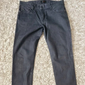 Gråa slim jeans J.Lindeberg Jay - Snygga grå jeans från J.Lindeberg, modell Jay. Byxorna har slim fit och midwaist, klassisk femficksdesign och är gjorda i ett mjukt bomullstyg med lite stretch. Perfekta för dig som gillar stilrena och moderna jeans.
