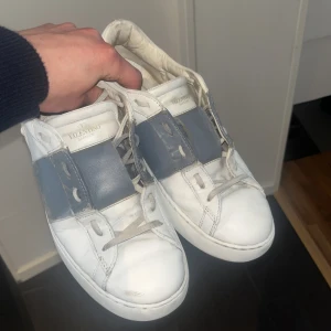 Valentino open  - Säljer mina vita och gråa Valentino open. Skorna är i storlek 42, i 7,5/10 skick pga defekten på sissta bilden. Annars ett par sköna skor i bra skick som är perfekta till sommaren.