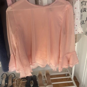 Puder rosa bluss med volang  - En rosa sommrig blus som inte använts mycket och köptes för något år sen från h&m 
