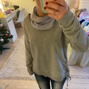 Tröja med knytning - Super cool grå sweatshirt med knytningar på sidorna!