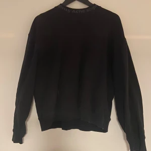 Svart tröja från Acne Studios - Säljer en svart tröja från Acne Studios i storlek XS. Tröjan är tillverkad i 100% bomull och har långa ärmar. Bra skick förutom att det är hål vid ena armbågen. Går säkert att laga.