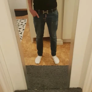 Jeans från DSQUARED2 - Snygga jeans från DSQUARED2 i en klassisk blå färg. De har en slim passform och är tillverkade i jeansmaterial. Byxorna har en knappgylf och ett lädermärke med DSQ2-logga baktill. Perfekta för en stilren look.