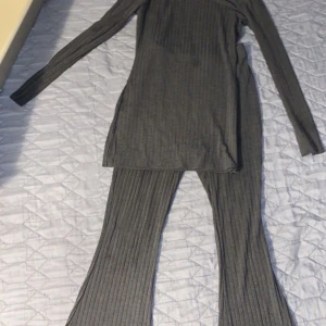 Grå ribbade byxor från SHEIN - Säljer ett par grå ribbade byxor från SHEIN i storlek XS. Byxorna har en rak passform och är tillverkade i ett mjukt, stretchigt material. Perfekta för en avslappnad och stilren look.