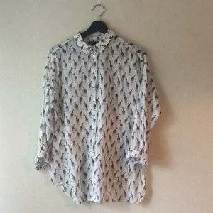  - Tunn och skönt skjorta från HM med giraffer på. Lite längre baktill.   Använd ett fåtal gånger. Pris inklusive frakt. 