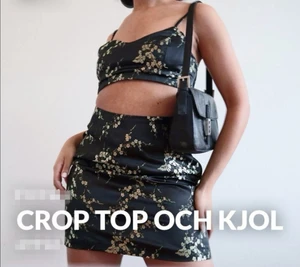 Co-ord set från NA-KD - Fint co-ord set med svart kjol och crop top med guldiga blommönster. Har alla lapparna kvar på plaggen. Från NA-KD. Strl 36. 