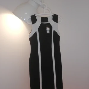 New Black and cream dress - New Knee-length black dress with geometric white cream line details. Falls just under the knee. Workwear. 