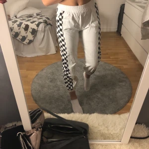 Coola byxor - 🤍Vita byxor med svarta och vita rutor på sidan.     🖤Luftiga och sköna, säljs pga att dom är försmå.  🤍Köparen står för frakt, 60kr. Stolek: 34-36, jag är 🖤en 36a.  Märke: Shein.  Byxorna är använde Max 🤍10ggr, är i nyskick.