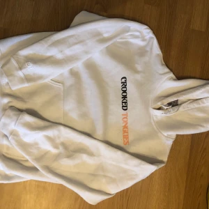 Vit hoodie strl S - Skitcool hoodie ifrån crooked tongues. Endast använd 2-3 gånger. Den passar både XS-M beroende på hur man vill att den ska sitta. Inte riktigt min stil längre därav väljer jag att sälja den 💘✨🤟🏻