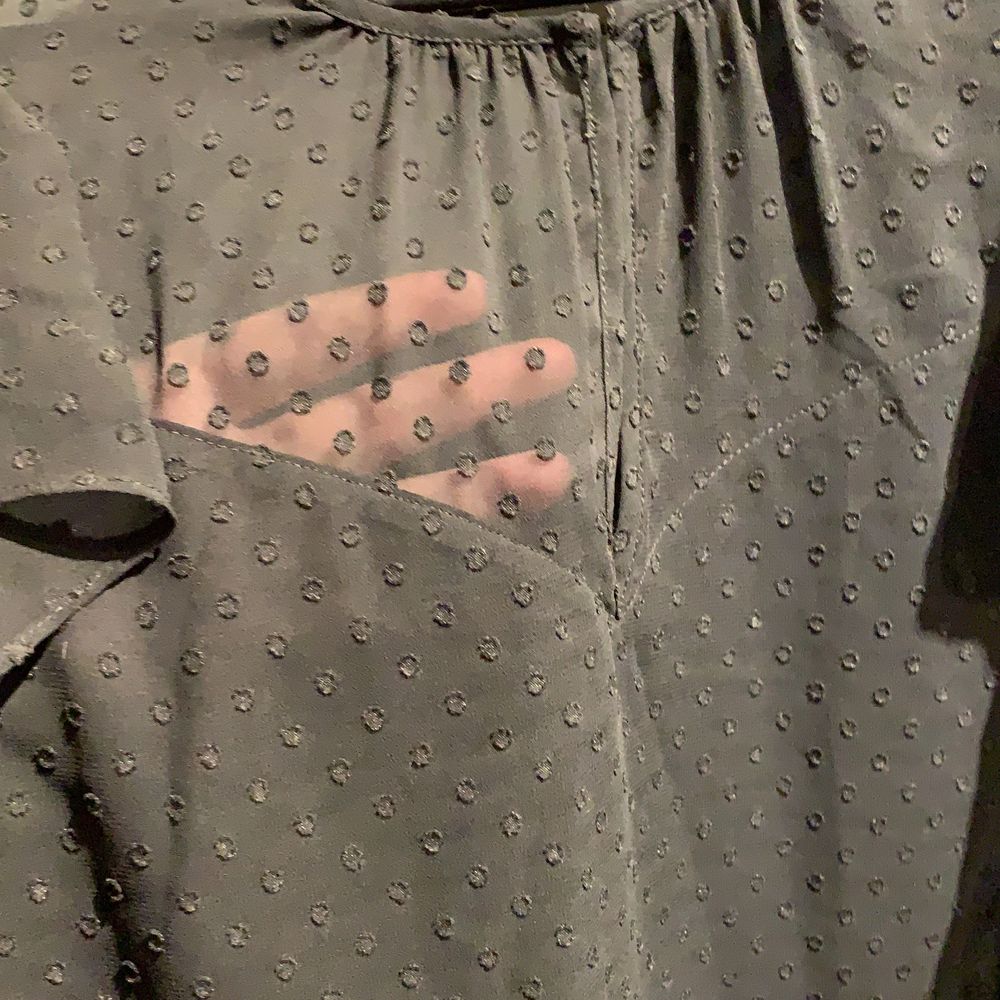 Söt svart blus från H&M med små svarta prickar och volanger vid axlarna.  Använd få gånger och är i bra skick, den är lite genomskinlig högst upp till både på fram och baksida (kolla sista bilden) . Blusar.