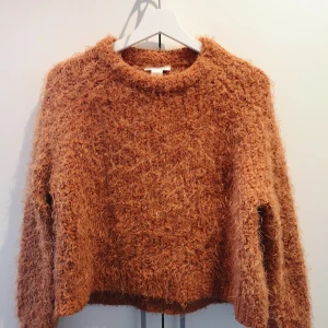 Supermysig lurvig kofta från Monki - En orange lurvtröja I storlek S. Men passar även de som har XS I storlek. Perfekt till hösten eller vintern. 