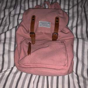 En rosa väska med ett ytter fack och ett inner fack det får plats mycket I den 