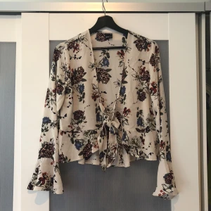  - Sjukt fin blommig blus från Gina Tricot. Knappt använd och är i perfekt skick. Jättesöt att ha nu till sommaren. Har knytning fram och volanger i ärmsluten.