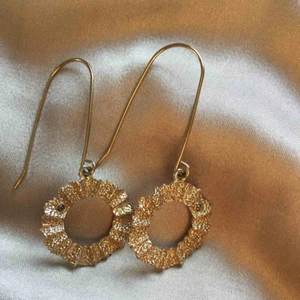  - Örhängen i blek guldfärg med en liten gnistrande sten. Bra skick.