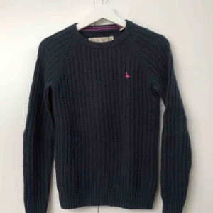 - Marinblå, kabelstickad tröja med rosa märke från Jack Wills. Storlek UK 8 vilket motsvarar 36 i EU. 