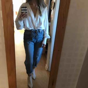  - Oanvänd ombloggad och slutsåld vit omlott bodysuit från Zara med silk-effekt. V-ringning, vida ärmar och stora knappar. Knäppning i nederkanten med tryckknapp. Stl L men ganska liten i storlek, känns som M. Ny med lapp kvar. Porto tillkommer.