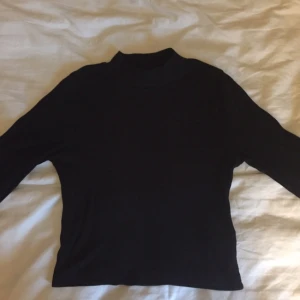  - Svart långärmad tröja med turtleneck, ribbad i tyget. Strl S, 40 kr