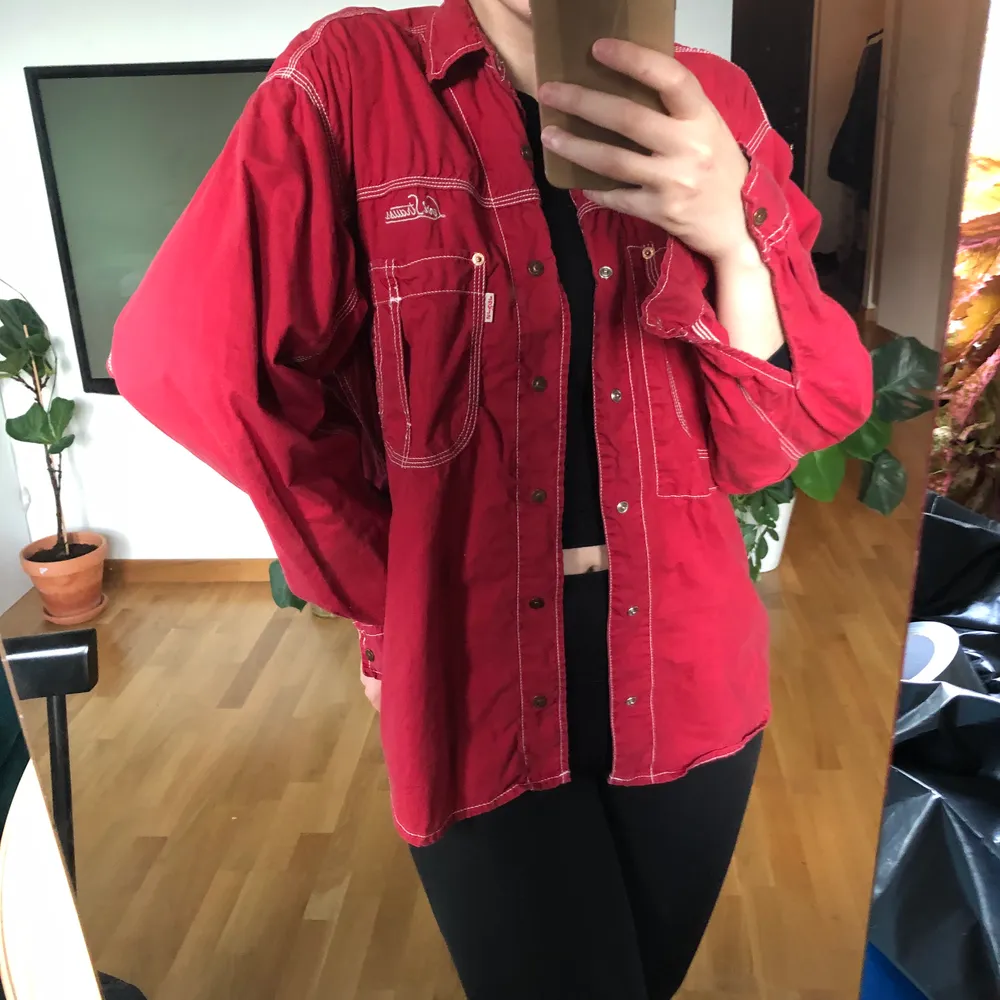 Röd vintageskjorta från Levis köpt av mig second hand. Väldigt bra skick och fint material! Jag har storlek XS/S och är 164cm lång. Frakt tillkommer. . Skjortor.