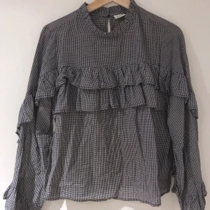 Rutig Volangblus strl 36 - Svart/Vit rutig volangblus från Gina Tricot. Fint skick! 