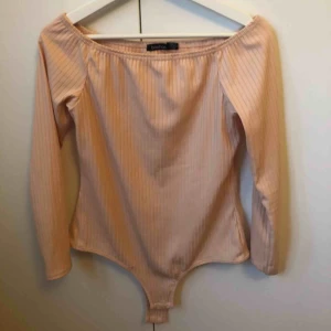  - Ribbad ljusrosa body från Boohoo.
