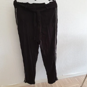  - Vida byxor med vita ränder på sidan! Ursäkta att de inte är strukna... Pris är inkl. Frakt!