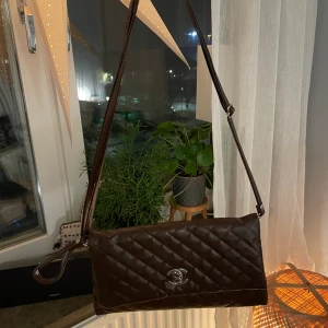 Chanel väska  - Funderar på att sälja den här superfina bruna Chanel väskan. Osäker på om den är äkta, men hur fin som helst ändå. Säljer den beroende på hur mycket jag skulle få, så om du är intresserad buda gärna i kommentarerna. LEDANDE BUD: 200kr