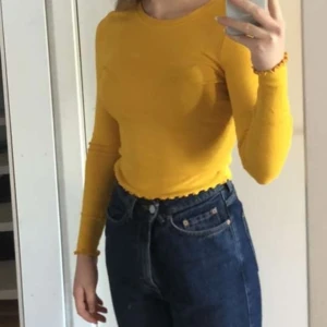 Senapsgul tröja strl S - Fin, ribbad, senapsgul tröja med "lettuce-hem". Väldigt stretchig i materialet och färgen beskrivs bäst på bild 2. Använd men i jättebra skick! Köparen står för frakt🌻
