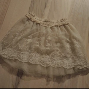  - Gullig Lite transparent kjol med broderade blommor.