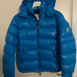 Moncler Maya i storlek 1/S. Väldigt fint skick, finns en liten fläck och cartoon är lös.