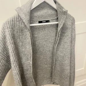 Grå stickad kofta från Bik Bok - Mysig grå stickad kofta från Bik Bok med dragkedja. Strl XS