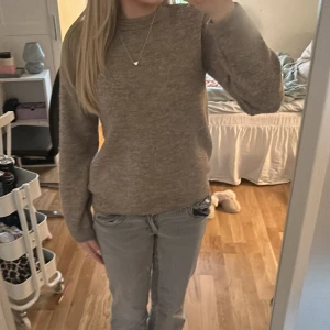 Beige stickad tröja - Mysig beige stickad tröja med långa ärmar. Perfekt för kyligare dagar och enkel att matcha med olika outfits.
