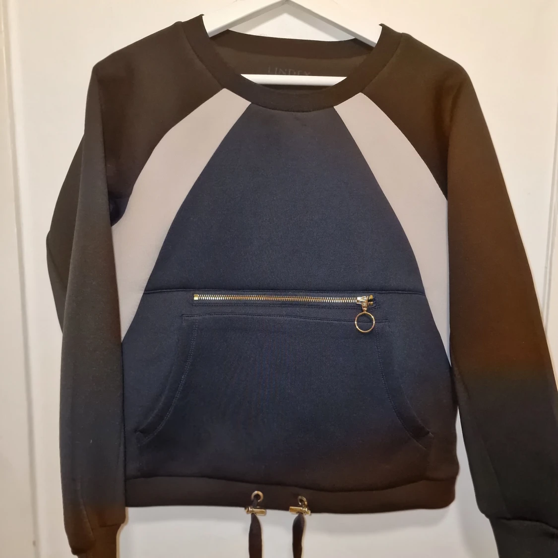 Svart och blå sweatshirt med dragkedja