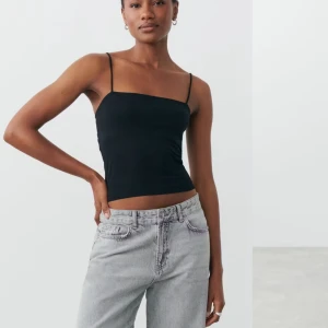 Svart linnetopp från Gina Tricot - Snygg svart linnetopp från Gina Tricot med smala axelband. Perfekt för en stilren look. Toppen är i en enkel design som passar till många olika outfits. Passar perfekt till sommaren eller att ha under en lång tjocktröja. Nypris 100kr. Säljer då den inte kommer till användning. 